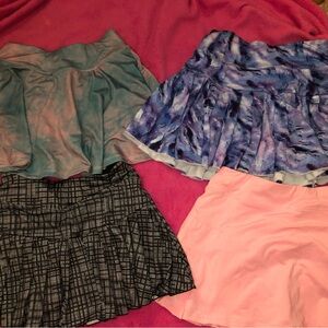 New unworn Set of 4 tennis workout skort skirts